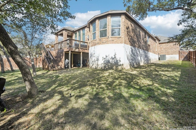 back of house featuring a deck and a yard