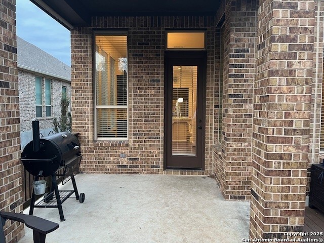 property entrance with a patio area