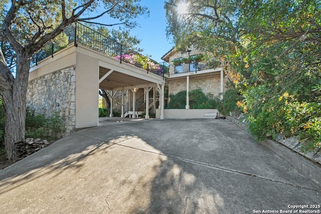 back of house featuring a patio and a carport