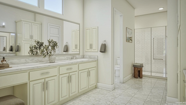 bathroom with vanity, a shower with shower door, and toilet