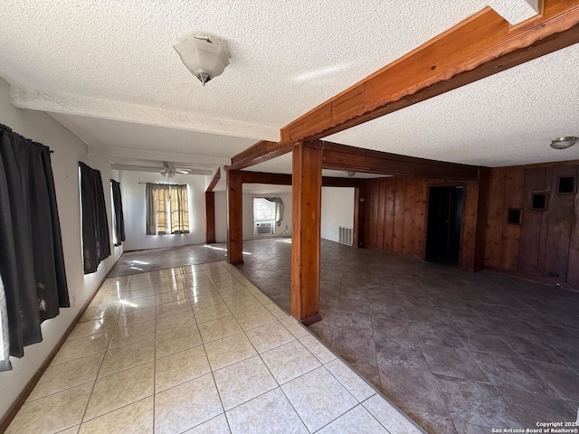 corridor with beam ceiling, a textured ceiling, cooling unit, and wooden walls