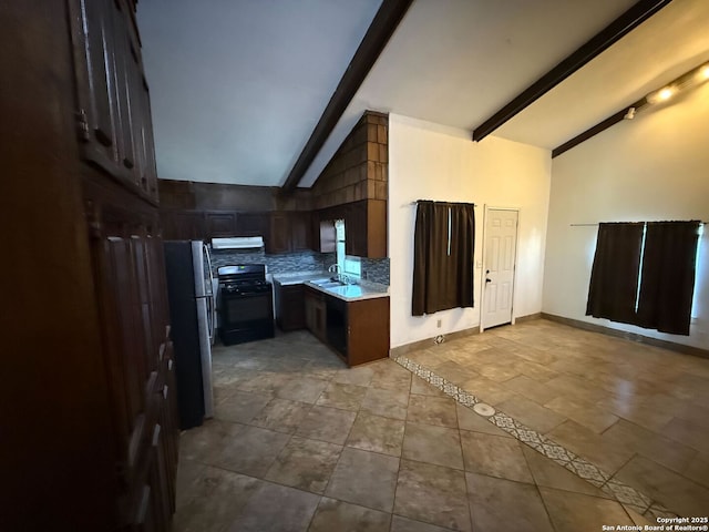 kitchen with refrigerator, backsplash, sink, beamed ceiling, and black range with electric stovetop