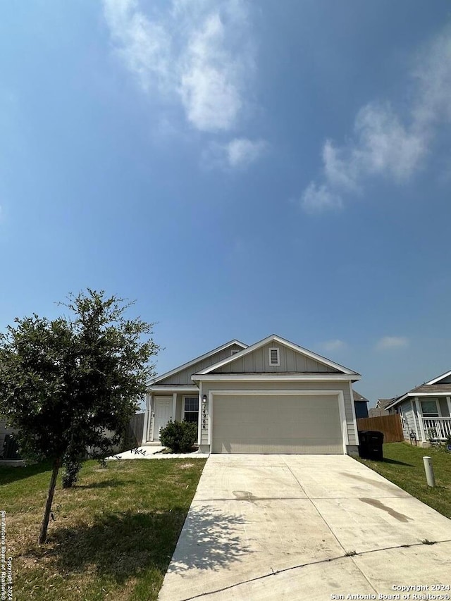 view of front of property with a garage and a front lawn