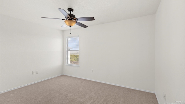 empty room featuring light carpet and ceiling fan