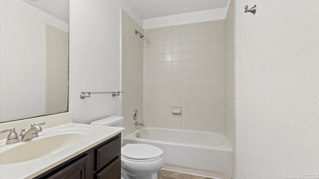 full bathroom with vanity, tiled shower / bath combo, and toilet