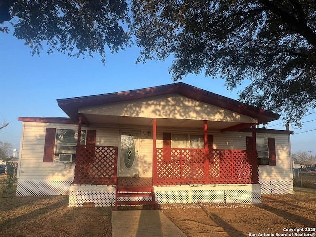 view of front of property featuring a porch and cooling unit