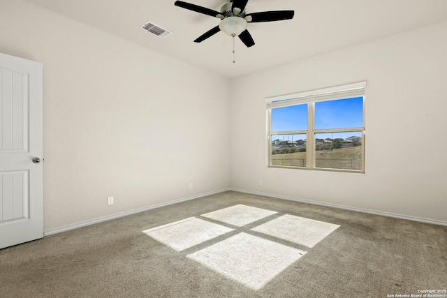 carpeted spare room with ceiling fan