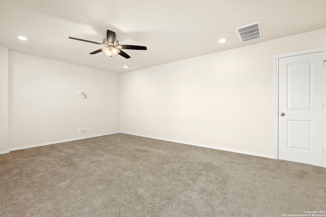 carpeted spare room featuring ceiling fan