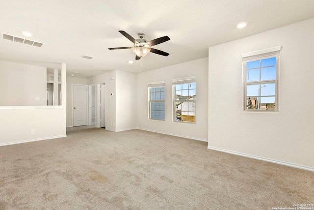 carpeted spare room with ceiling fan