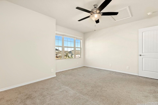 spare room featuring light carpet and ceiling fan