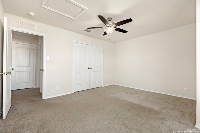 unfurnished bedroom featuring carpet flooring, ceiling fan, and a closet