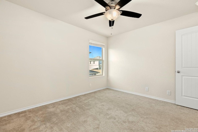 spare room with light carpet and ceiling fan