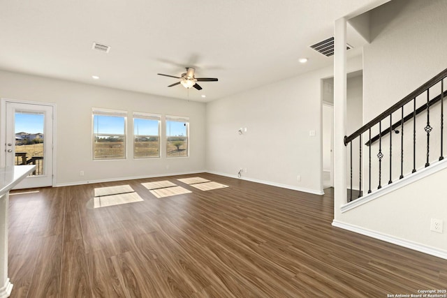 unfurnished living room featuring ceiling fan and dark hardwood / wood-style flooring