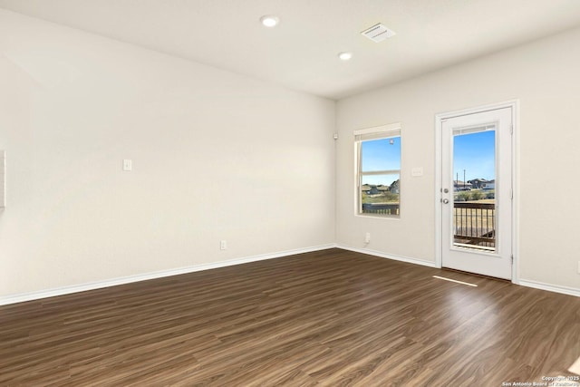 unfurnished room with dark hardwood / wood-style floors