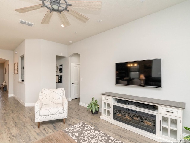 living area with ceiling fan and light wood-type flooring