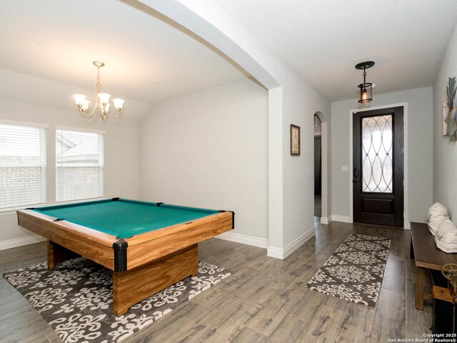 playroom with vaulted ceiling, wood-type flooring, a notable chandelier, and pool table