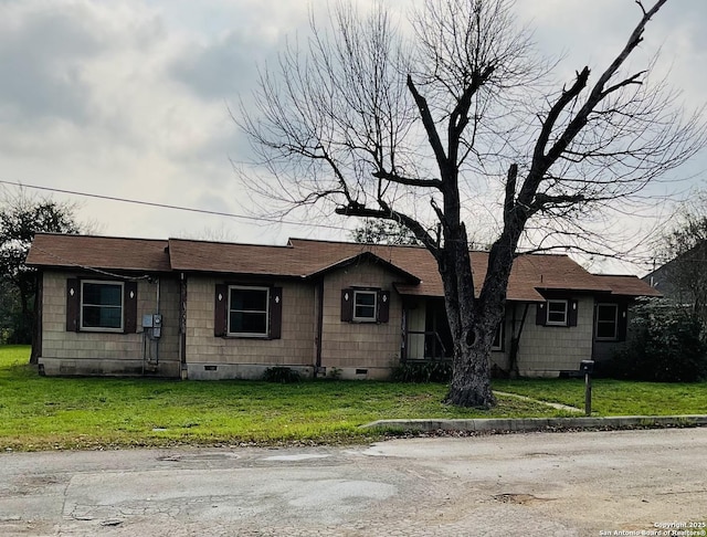 ranch-style house with a front lawn