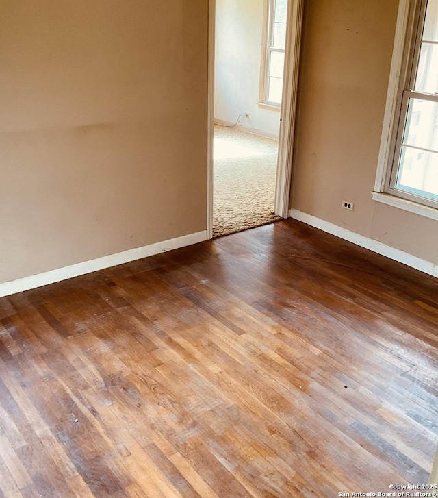 unfurnished room with hardwood / wood-style floors