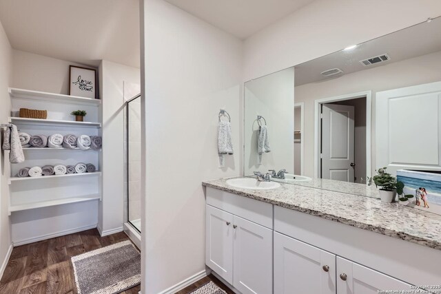 2917 Brogan Crk, New Braunfels, TX 78130 - bathroom with wood-type flooring, vanity, and an enclosed shower