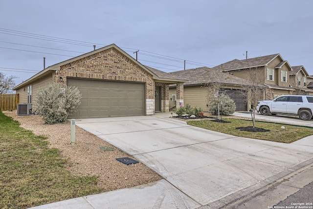 ranch-style home with central AC unit and a garage