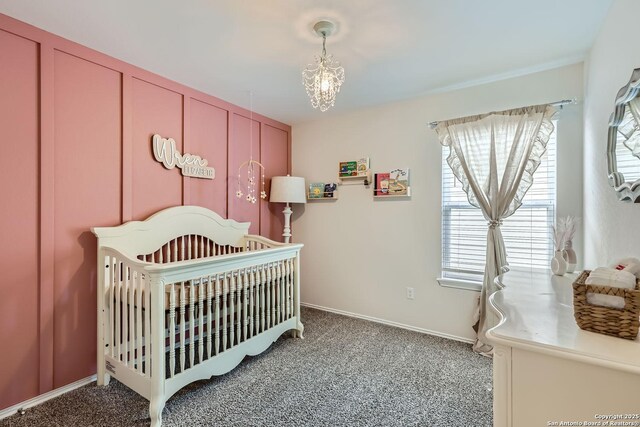 2917 Brogan Crk, New Braunfels, TX 78130 - bedroom with carpet flooring, a crib, and an inviting chandelier