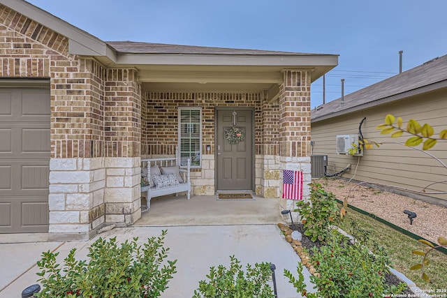 2917 Brogan Crk, New Braunfels, TX 78130 - view of exterior entry featuring covered porch, ac unit, central AC, and a garage