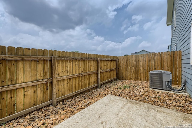 view of yard featuring central air condition unit and a patio