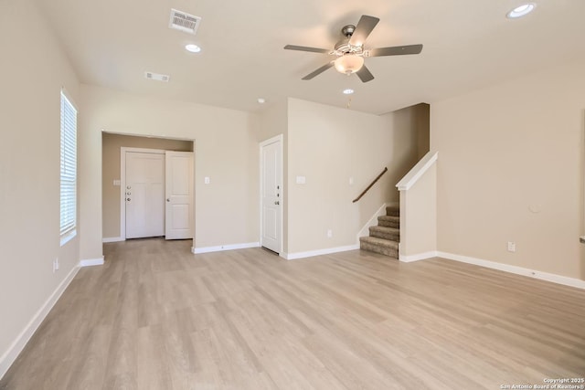 unfurnished living room with ceiling fan and light hardwood / wood-style flooring