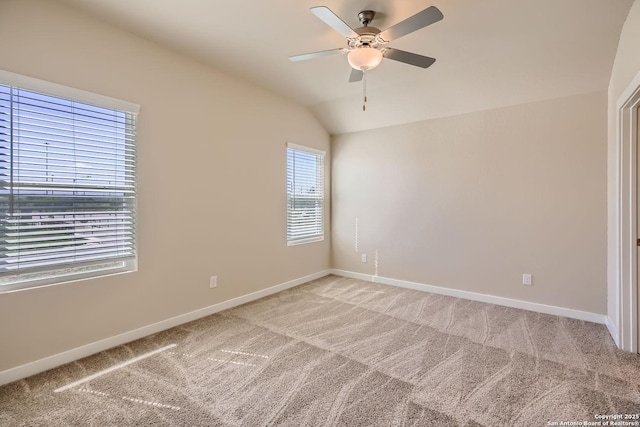 spare room featuring light colored carpet, ceiling fan, and lofted ceiling