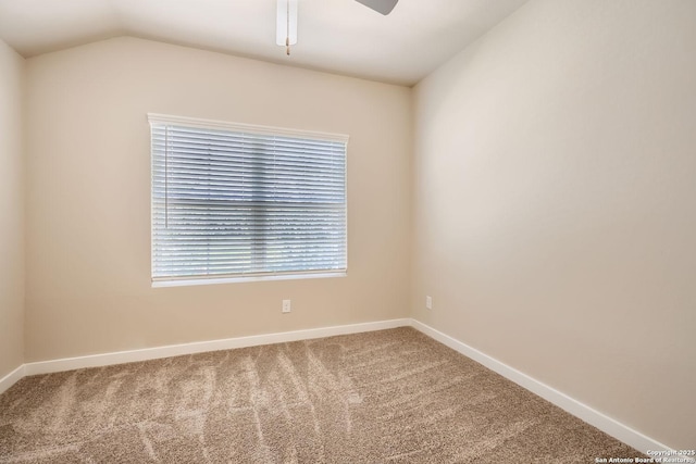 carpeted spare room with vaulted ceiling and ceiling fan