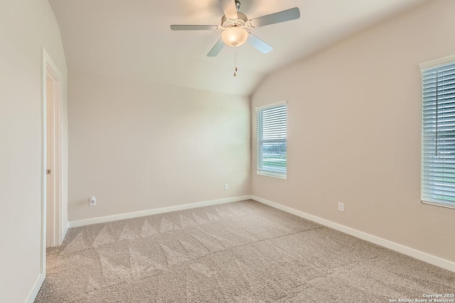 carpeted empty room featuring ceiling fan and lofted ceiling