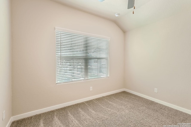 carpeted empty room with ceiling fan and lofted ceiling