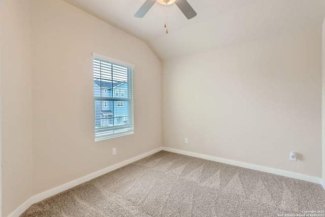 carpeted spare room featuring ceiling fan and lofted ceiling