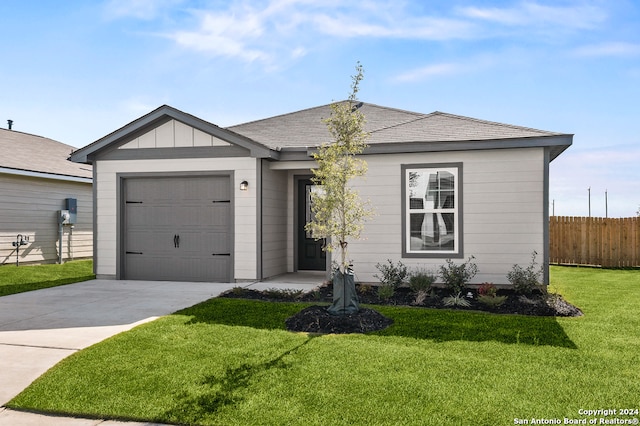 single story home featuring a garage and a front lawn