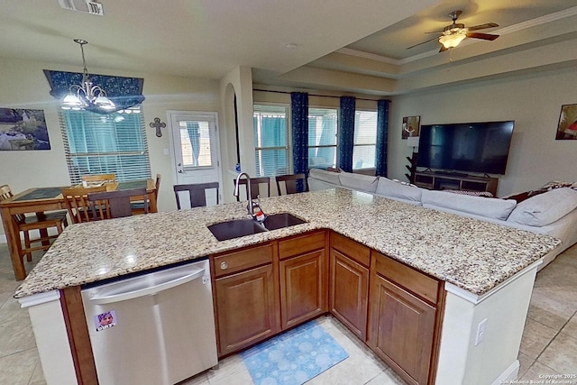 kitchen with a tray ceiling, crown molding, sink, decorative light fixtures, and dishwasher