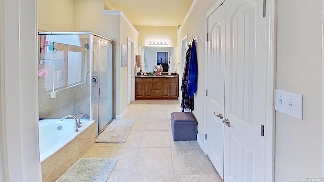 bathroom with tile patterned floors, plus walk in shower, and vanity