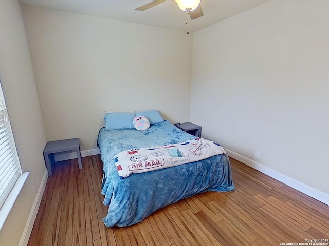 bedroom featuring hardwood / wood-style flooring and ceiling fan