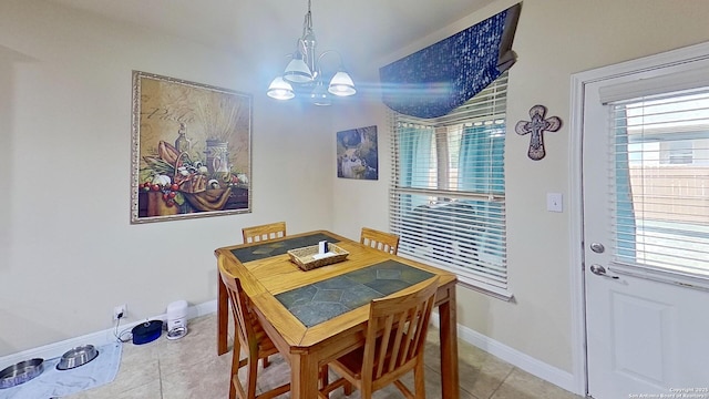 dining room with light tile patterned floors, an inviting chandelier, and plenty of natural light