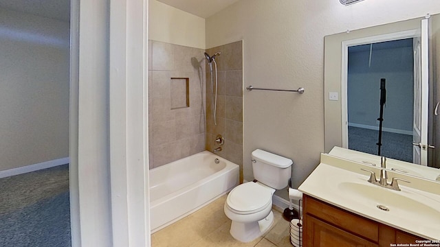 full bathroom featuring tiled shower / bath, vanity, and toilet