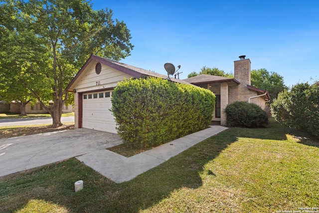 view of front of house featuring a garage and a front lawn