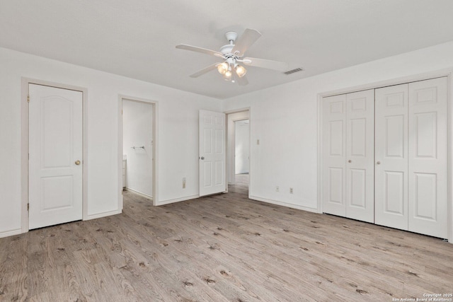 unfurnished bedroom with ceiling fan and light wood-type flooring