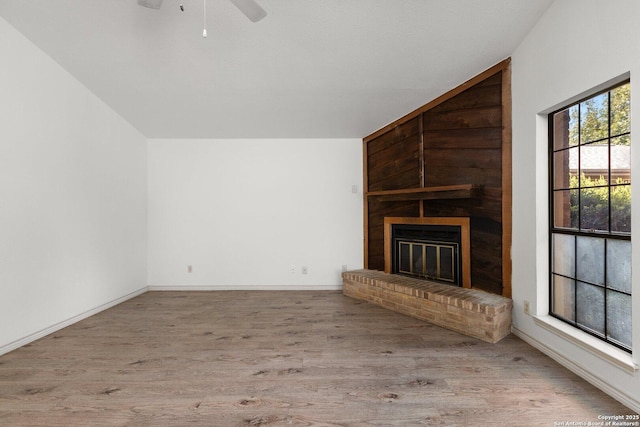 unfurnished living room featuring ceiling fan, light hardwood / wood-style floors, and a fireplace