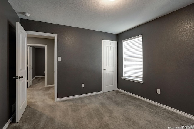 unfurnished bedroom with carpet and a textured ceiling