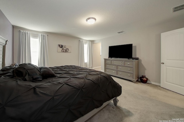 carpeted bedroom featuring a textured ceiling