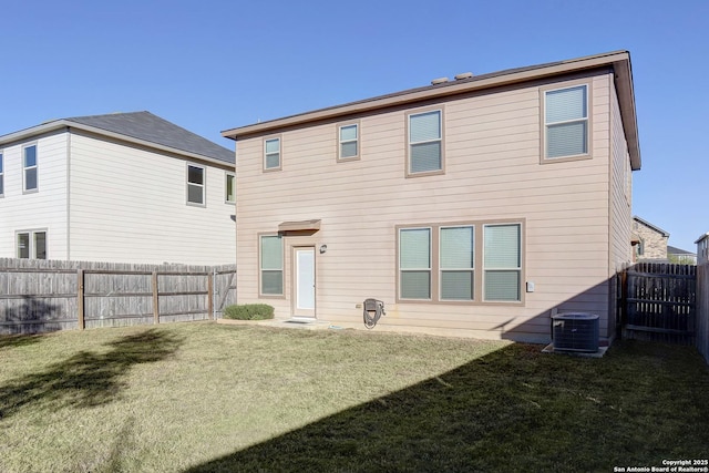 back of house featuring cooling unit and a yard