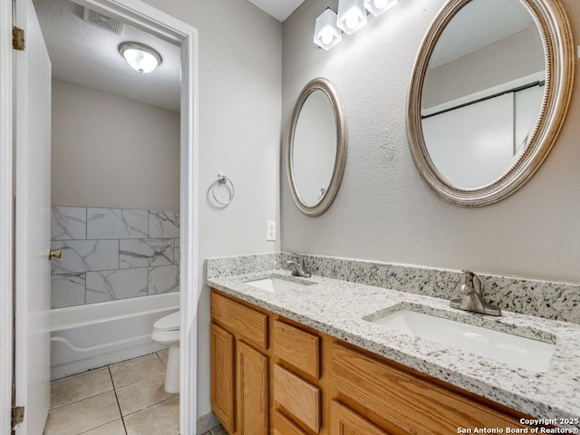 full bathroom with tile patterned flooring, vanity,  shower combination, and toilet