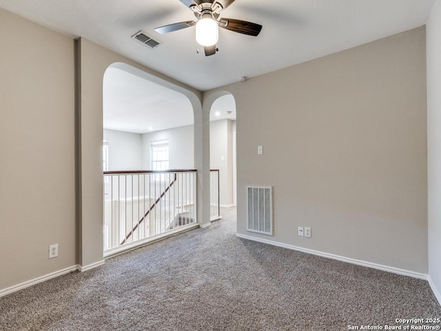 empty room with ceiling fan and carpet floors