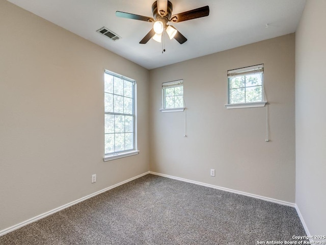 empty room with ceiling fan and carpet floors