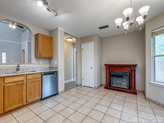 kitchen with dishwasher, ceiling fan with notable chandelier, hanging light fixtures, sink, and light tile patterned floors