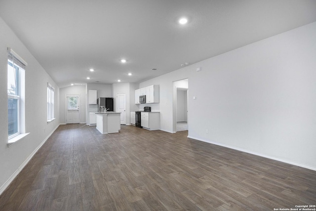 unfurnished living room with sink and dark hardwood / wood-style flooring